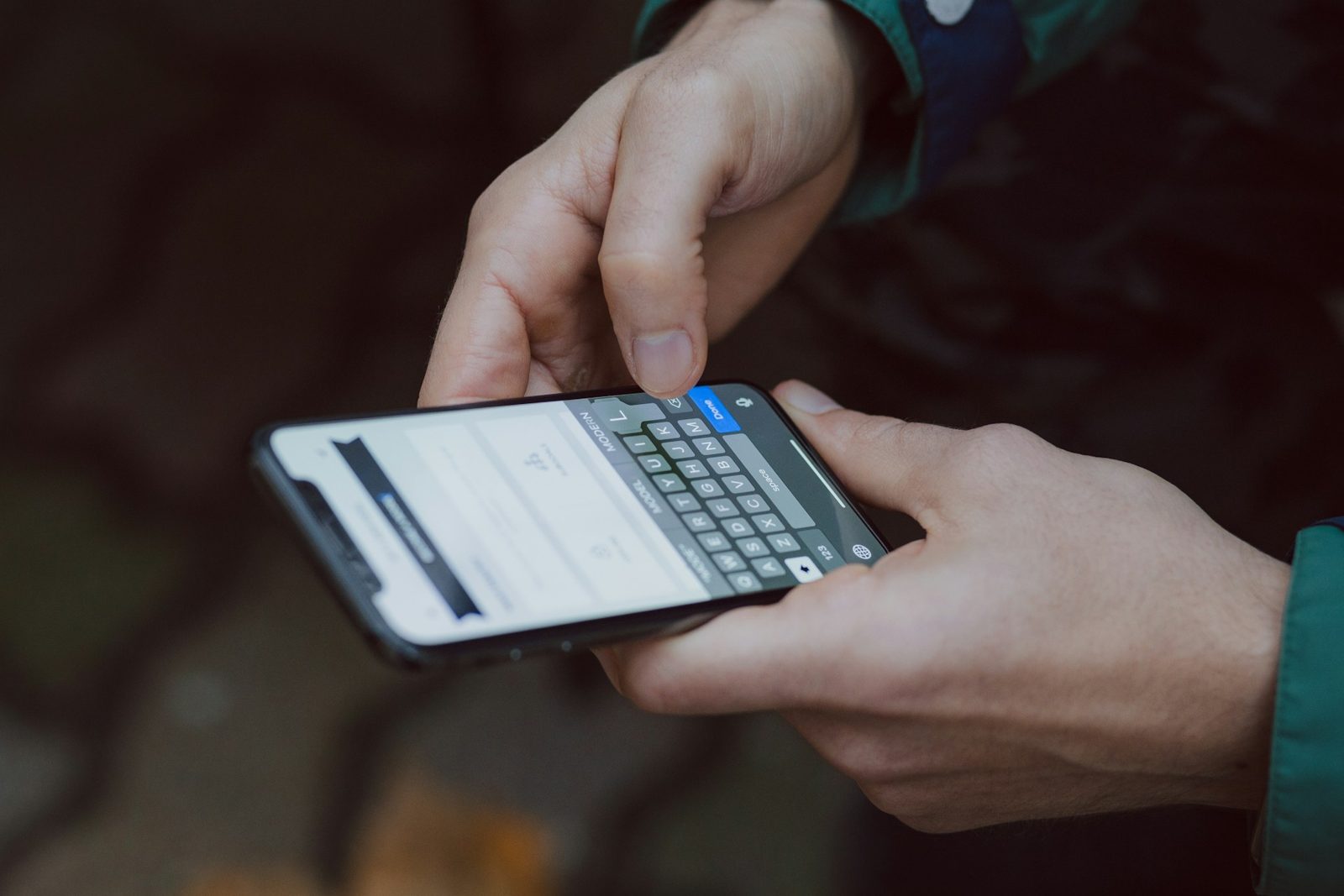 Tangan mengetik pesan di smartphone